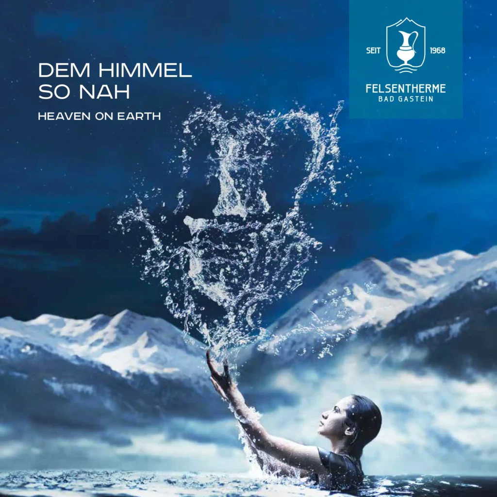 Frau im Wasser vor verschneiten Bergen mit Wasserfontäne und Logo Felsentherme Bad Gastein seit 1968
