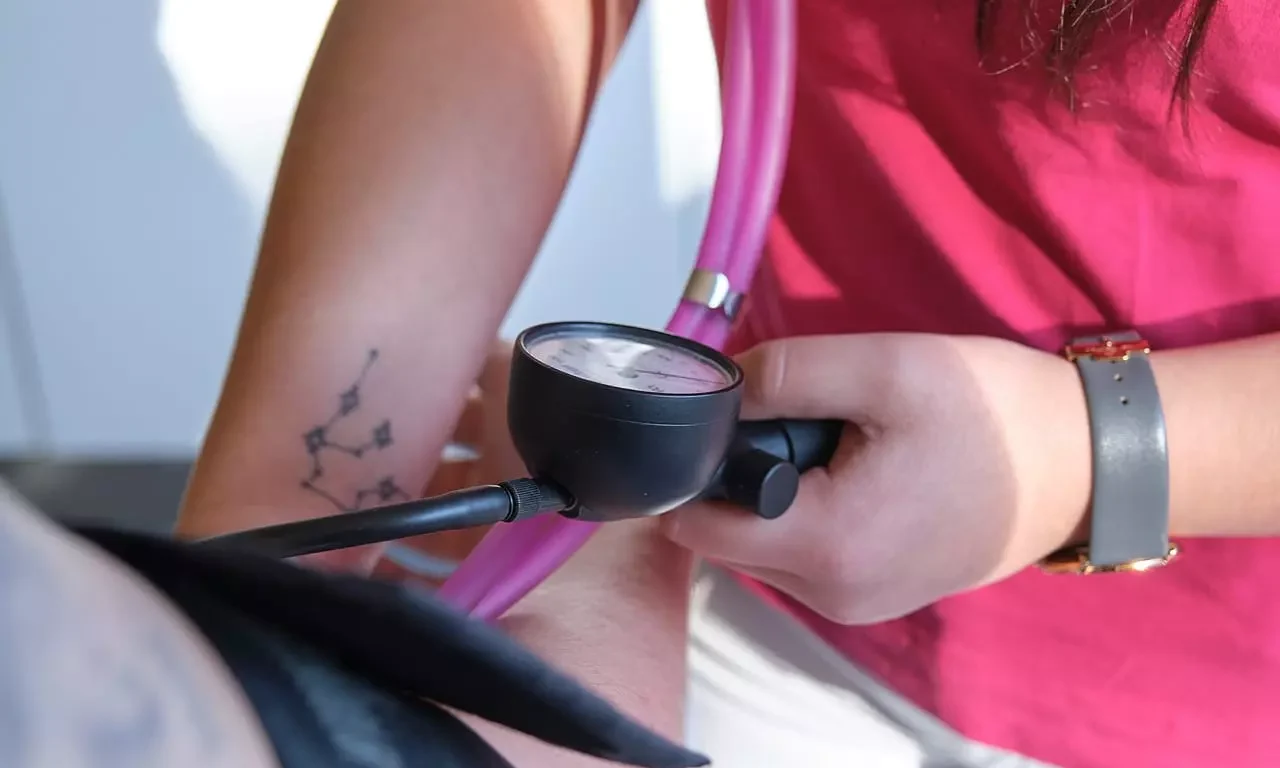 Frau misst Blutdruck bei Patient im medizinischen Bereich des Gesundheitszentrums Bärenhof Bad Gastein